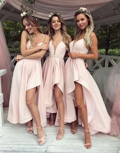 three beautiful women standing next to each other in pink dresses with high thigh slits