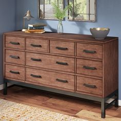 a dresser with two mirrors above it and a vase sitting on top of the dresser