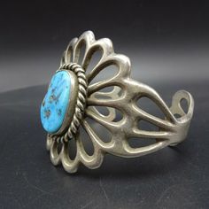 "VINTAGE NAVAJO BRACELET DESCRIPTION: With a gorgeous cab of blue Kingman turquoise, this classic sand cast bracelet will be a cherished addition to your collection of fine vintage Native American jewelry. MEASUREMENTS: Interior of the cuff measures 5 3/4\" with an additional 1 1/4\" slightly adjustable gap. Total circumference: 7\" Measures 2 1/2\" straight across the widest part (from wrist bone to wrist bone) Bracelet face measures 2 1/8\" wide (the face of the bracelet, north to south) Caboc Western Style Blue Cuff Bangle Bracelet, Western Style Blue Bangle Jewelry, Western Style Engraved Blue Jewelry, Vintage Blue Oval Bracelets, Vintage Blue Oval Bracelet, Southwestern Engraved Blue Cuff Bracelet, Vintage Turquoise Engraved Bracelets, Blue Oval Vintage Cuff Bracelet, Southwestern Blue Cuff Bracelet With Patina