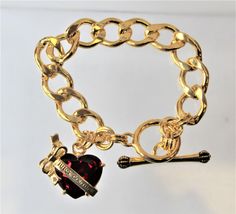 Gorgeous Charm Bracelet with a large red heart. This bracelet is stunning. This is a juicy couture remake, not an original. The bracelet is 7.5 in. long gold curb chain with a stick and circle clasp. Luxury Heart Charm Bracelet For Valentine's Day, Luxury Heart Pendant Bracelet As Gift, Luxury Heart Bracelet As Valentine's Day Gift, Luxury Heart Bracelet For Valentine's Day, Luxury Heart Charm Chain Bracelet As Gift, Luxury Adjustable Bracelets With Heart Charm, Luxury Chain Bracelet With Heart Charm For Gift, Luxury Classic Bracelets With Heart Charm, Luxury Charm Bracelet With Polished Finish And Round Shape