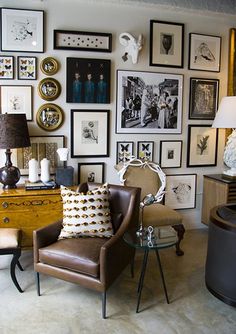 a living room filled with furniture and pictures on the wall