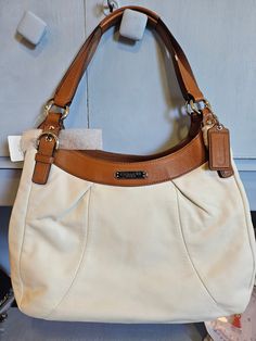 Beautiful vintage Coach with cream leather and saddle leather finishes. Pink Satin inside with large openings! Brown Leather Bag With Lined Interior, Luxury Leather Shoulder Bag With Lined Interior, Classic Tote Shoulder Bag With Lined Interior, Classic Cream Bags With Leather Lining, Leather Satchel With Lined Interior, Leather Satchel Bag With Lined Interior, Leather Shoulder Bag With Double Handle And Lined Interior, Cream Bag With Leather Lining And Double Handle, Leather Tote Shoulder Bag With Lined Interior