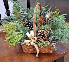 a basket filled with pine cones and greenery