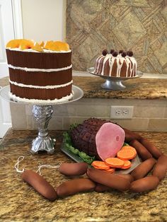 there is a cake on the counter with carrots and other food items next to it