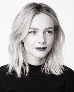 a black and white photo of a woman with blonde hair wearing a turtle neck sweater