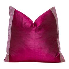 a pink and silver pillow on a white background