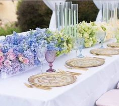 a table with flowers and plates on it