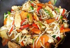 a wok filled with stir fry vegetables and noodles