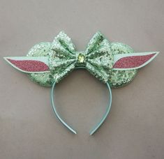 a green and pink minnie mouse ears with sequins