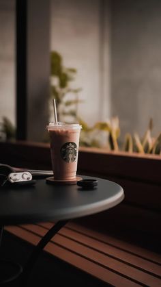 a starbucks drink sitting on top of a table