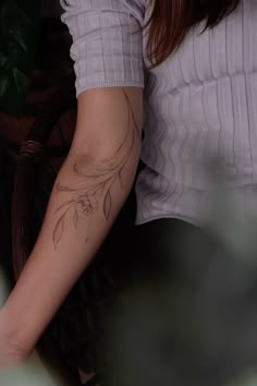 a woman with a tattoo on her arm