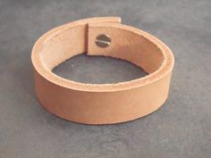 This beautiful leather bracelet was made using high quality leather and will wear wonderfully with age. The leather cuff is provided with a strong silvery rivet, for a quick and easy closure.Guidelines : ● wide: 1.7 cm (0.7")● long: 17 cm (6.7") long (from a snap to another) -> It would best fit a 15 cm (6") wrist. ● thick: 3 mmIt will definitely add a sweet touch to your outfit! *** It will be packed in a linen bag, hand stamped with a black arrow that would make a pretty keepsake. *** For more Beige Leather Jewelry, Bracelet For Her, Womens Bracelet, Black Arrow, Bracelet Leather, Boho Bracelet, Bracelet Boho, Linen Bag, Leather Key