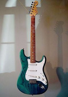 an electric guitar hanging on the wall