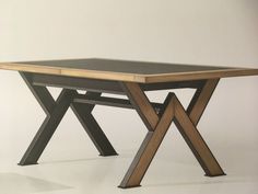 a table with two wooden legs and a black top