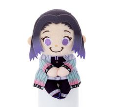 a small stuffed doll sitting on top of a white tube with purple hair and eyes