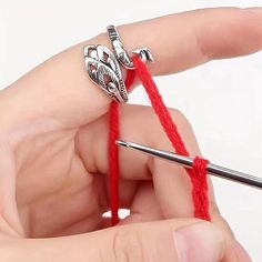 a person knitting yarn with a crochet hook