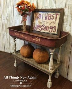 an old wooden shelf with two pumpkins on it and a sign that says harvest blessing