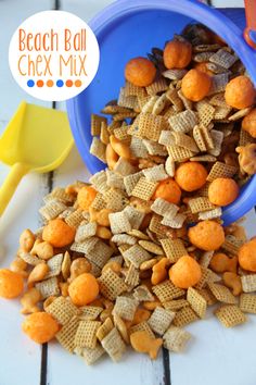 a blue bowl filled with chex mix next to a yellow and orange scooper