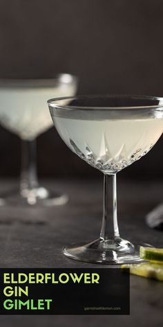 two glasses filled with white liquid sitting next to each other on top of a table