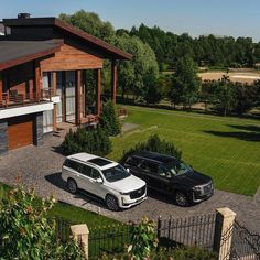 two cars parked in front of a house