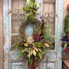 a wreath is hanging on an old door