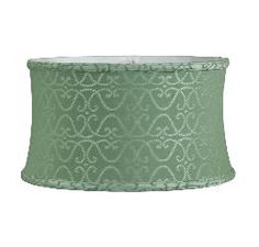 a green lamp shade with an intricate design