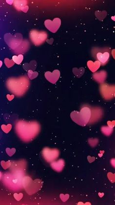 many pink hearts floating in the air on a black and purple background with space for text