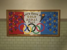 a sign that says let's have a gold medal in front of the olympics