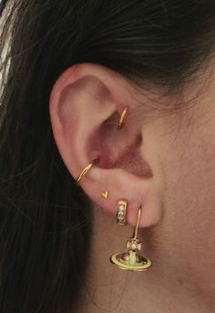 a close up of a person's ear with two different types of piercings