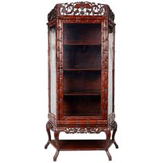 an ornate wooden bookcase with glass doors