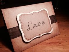 a close up of a card on a wooden surface with the word larua