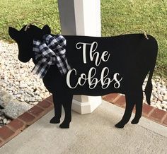 a black and white cow with the words the cobs painted on it's side