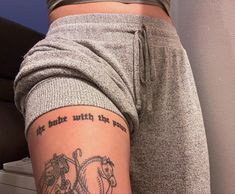 a woman with a tattoo on her lower leg and the words, if she wants to be with the horse