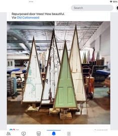 several surfboards are stacked on wooden boards in a garage with other items behind them