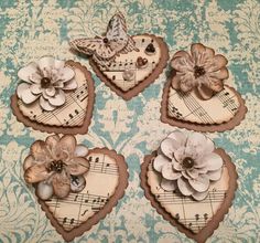 four heart shaped cookies decorated with flowers and music notes