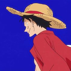 a man wearing a straw hat looking down at something blue in the sky behind him