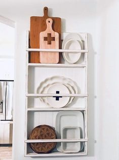 a shelf with plates and cutting boards on it