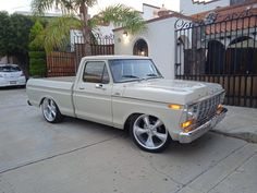 a white pickup truck parked in front of a house