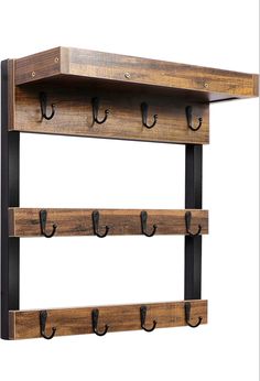 a wooden shelf with hooks on it