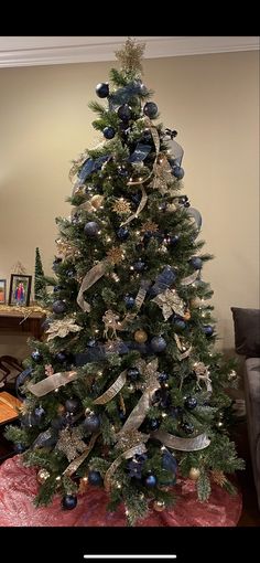 a christmas tree with blue and silver decorations