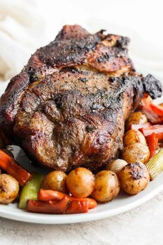 a white plate topped with meat and veggies