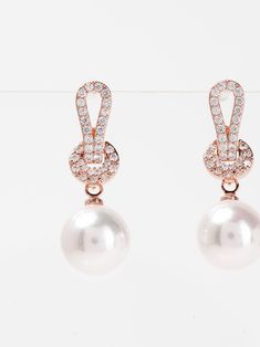 Elevate your style with Jemma Knott's expertly crafted White Gold plated Pearl Drop Earrings. The timeless combination of exquisite pearls and gold plating adds a touch of elegance to any outfit. These beautifully designed earrings are perfect for completing a sophisticated and polished look. SizeL: 1.75" QualityMade with quality materials for endurance. ImportedECZ1560 Formal Pearl Chain Round Earrings, Formal Round Pearl Chain Earrings, Formal Rose Gold Pearl Earrings, Classic Rose Gold Pearl Earrings For Parties, Elegant Rose Gold Earrings With Pearl Chain, Elegant Pearl Clip-on Earrings For Formal Occasions, Rose Gold Pearl Round Earrings, Rose Gold Pearl Earrings For Party, Rose Gold Round Pearl Drop Bridal Earrings