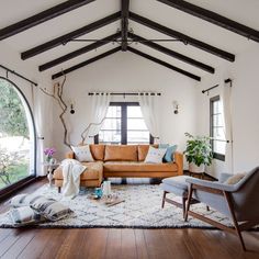 a living room filled with furniture and windows