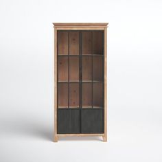 a wooden bookcase with glass doors on the front and bottom shelves, against a white background