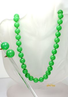 "This is an original Art Deco 1930s vintage green faux Jade Celuloid / Early Plastic jewelry set: beaded necklace and clip-on earrings. The necklace measures almost 29\" long, it weighs 1.4 oz and the beads are 3/8\" in diameter. The earrings are 3/4 in diameter and the weight of one earring is 0.1 oz. It is a vintage item in excellent condition. We combine shipping, If you want to take advantage of the reduced shipping you must contact us before you pay for your items so we can send you a corre Formal Green Beaded Necklace, Retro Green Beaded Necklace For Gift, Vintage Green Round Beaded Jewelry, Vintage Jade Beaded Necklaces, Vintage Jade Jewelry With Round Beads, Vintage Green Round Bead Jewelry, Vintage Green Jewelry With Faceted Beads, Vintage Green Round Beads Jewelry, Vintage Hand-strung Green Beaded Necklaces