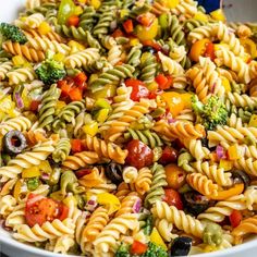 a bowl filled with pasta salad on top of a table