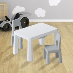 a white table and chair in a child's room