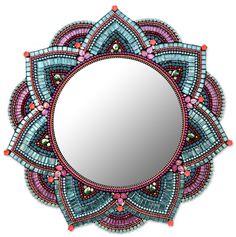 a circular mirror with beaded designs on it