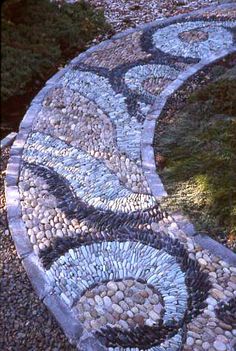 a stone bench made out of rocks and stones in the shape of a spiral design