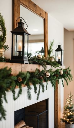 a mantel decorated with pine cones, evergreen branches and a lantern on the mantle